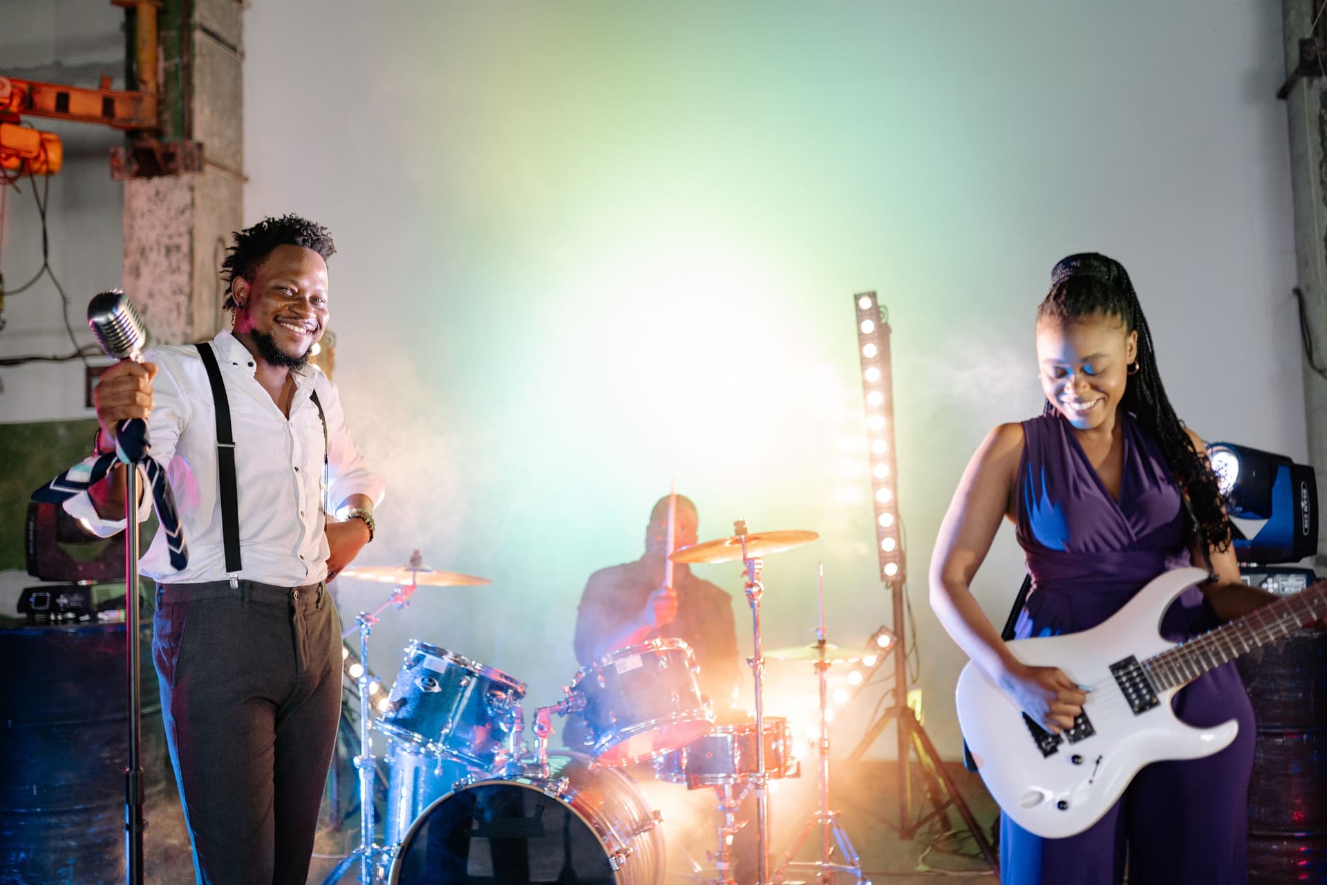 Two performers on stage facing a live audience
